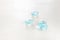 Delicate blue gemstones beads on white wooden background