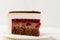 Delicate cake with chocolate cream, cherry jam on a white background.