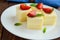 Delicate cottage cheese and creamy souffle in the form of cubes, decorating with mint leaves and fresh strawberries