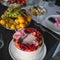 Delicate and delicious pink cake with cream and berries. Beautiful birthday cake on the table,