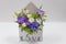 Delicate floral arrangement gift of fresh flowers in a box in the form of an envelope with the inscription Love, on a light back