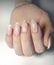 Delicate French manicure with marble design. French design. Women`s fingers with beautiful long nails.