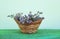 Delicate lavender lilac flowers collected in a straw basket in the summer garden