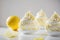 Delicate lemon mousse atop fluffy meringues on white background with copy space. Generative AI