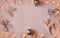 Delicate pink background with Christmas lights, ball, shiny deer and butterfly. New year