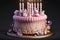 delicate pink bunt birthday cake with burning candles and decorations