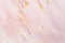 Delicate pink marble background with gold brushstrokes. Place for your design