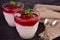 Delicate rice pudding with sweet and sour cherry jam on a black background.