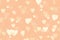 Delicate romantic light background with many hearts, Peach Fuzz color, color of the year 2024