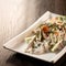 Delicate salad of pickled honey mushrooms, fresh vegetables and herbs on wooden table. Close up shot. Soft focus