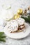 Delicate shortbread cookies with nuts and powdered sugar on a light gray background in the New Year decorations