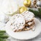 Delicate shortbread cookies with nuts and powdered sugar on a light gray background in the New Year decorations