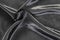 Delicate smooth soft black silk fabric background. Abstract crumpled satin texture.