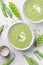 Delicate spring green cream soup with green peas and mint, white background. Spring or summer vibrant healthy vegetarian menu