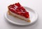 delicate strawberry cheesecake on a white plate. macro