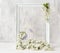 Delicate vintage white frame with vibrant cherry blossoms on a light gray background. Decorative cage with birds.