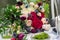 Delicate wedding bouquet with burgundy cream pink roses and feverweed, closeup