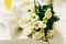 Delicate wedding bouquet made of callas lies on the white table