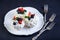 Delicate white meringues with fresh berries on the plate. Dessert Pavlova close-up. Wedding cake.