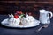 Delicate white meringues with fresh berries on the plate. Dessert Pavlova close-up. Wedding cake.