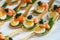 Delicates, appetizer filling with red fish, quail egg, black caviar and lime. Catering service.