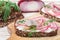 Delicatessen open sandwich smorrebrod with herring, red onions, cream cheese ricotta and dill