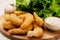 Delicatessen shrimp in breaded closeup with salad, garlic and sauce