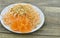 Delicios carrot, kohlrabi and peanuts on wooden background.