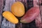 Delicious 3 Ripe Mangos on wood as Mahachanok Mango, R2E2 Mango