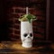 Delicious alcoholic cocktail with mint in a skull-mug