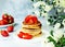 Delicious american pancakes with sweet strawberries. Breakfast time concept.
