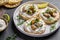 Delicious antipasti bruschetta with mussels, Crisp bread, soft cheese and arugula salad. Set of tasty appetizer sandwiches. top