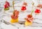 Delicious appetizers with prosciutto and pineapple on marble banquet table. Catering food, canape and snacks, close up.