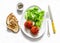 Delicious appetizers, tapas - stuffed roasted tomatoes, lettuce and grilled bread on a light background, top view