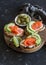 Delicious appetizers with wine - cream cheese, smoked salmon and avocado sandwiches and olives