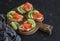 Delicious appetizers with wine - cream cheese, smoked salmon and avocado sandwiches and olives