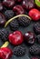 Delicious and appetizing fruits of the forest, blackberries and fresh and raw cherries.