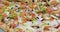 Delicious and appetizing pizza is spinning closeup video 4k