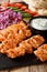 Delicious Arabian Taouk chicken skewers with fresh vegetables, yogurt sauce and pita close-up. vertical