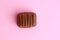 Delicious assorted chocolate bonbon on a pink surface