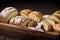 Delicious Assortment of Baked Bread and Rolls on a Rustic Black Bakery Table Counter.