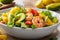 Delicious Avocado, Mango, Shrimp, and Olive Oil Salad with Fresh Greens.