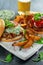 Delicious Bagel Pork sandwiches with vegetable and Tzatziki Sauce and Fries on white board.