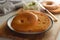 Delicious bagels with cream cheese on wooden board, pastry bread for breakfast