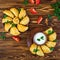 Delicious baked empanadas on wooden background