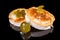Delicious baked gourmet goat cheese with walnuts with reflection