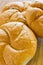 Delicious baking round buns made on a wooden table background.