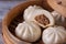 Delicious baozi, Chinese steamed meat bun is ready to eat on serving plate and steamer