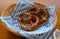 Delicious Bavarian Brezeln or pretzels with a brown salty crust on a traditional Bavarian cocktail napkin in a basket