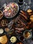 Delicious BBQ ribs served with coleslaw, cornbread, and sauces on a rustic table setting.